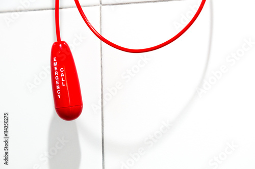 Red bathroom emergency pull cord in hospital