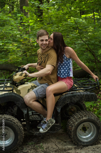 couple kisses on an ATV