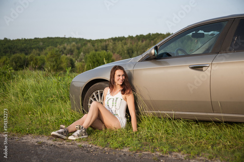girl sitting by the car © tamarabegucheva