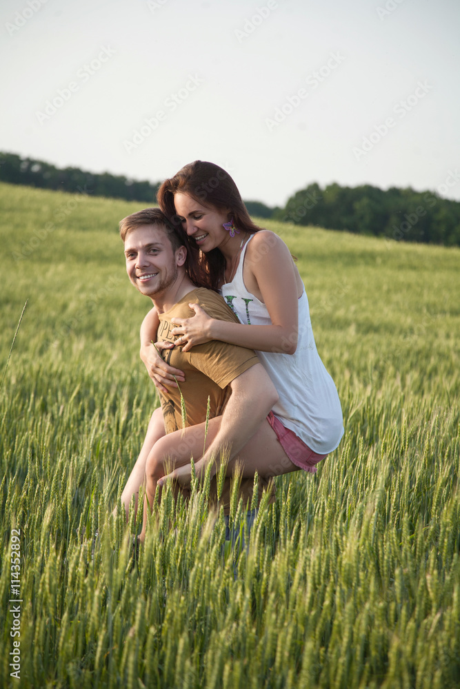 A man giving his girlfriend a piggyback A man giving his girlfriend a piggyback