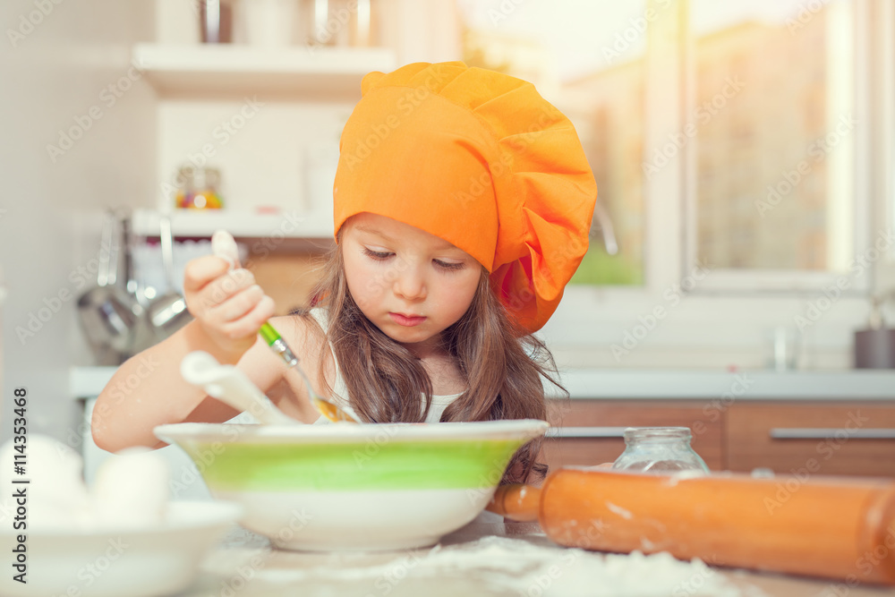 beautiful cute little girl with bonnet making pasta dough in kitchen beautiful cute little girl with bonnet making pasta dough in kitchen