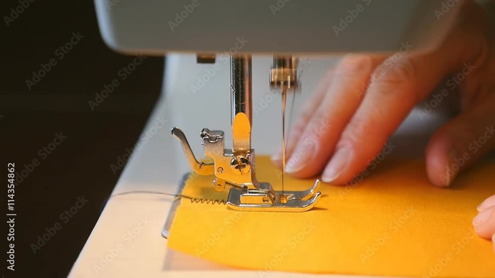 Woman sewing on the sewing machine slow motion Stock Video Adobe Stock