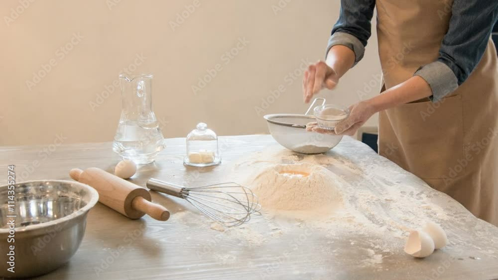 Pleasant baker making dough Pleasant baker making dough