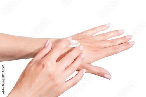 Female beautiful delicate manicured hands with moisturizing cream isolated on white background