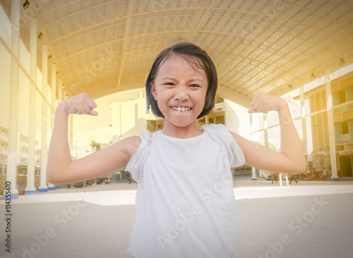 Superhero child against Roof steel frame background. Kid playing outdoor. Girl power concept.Light Filter Effect.