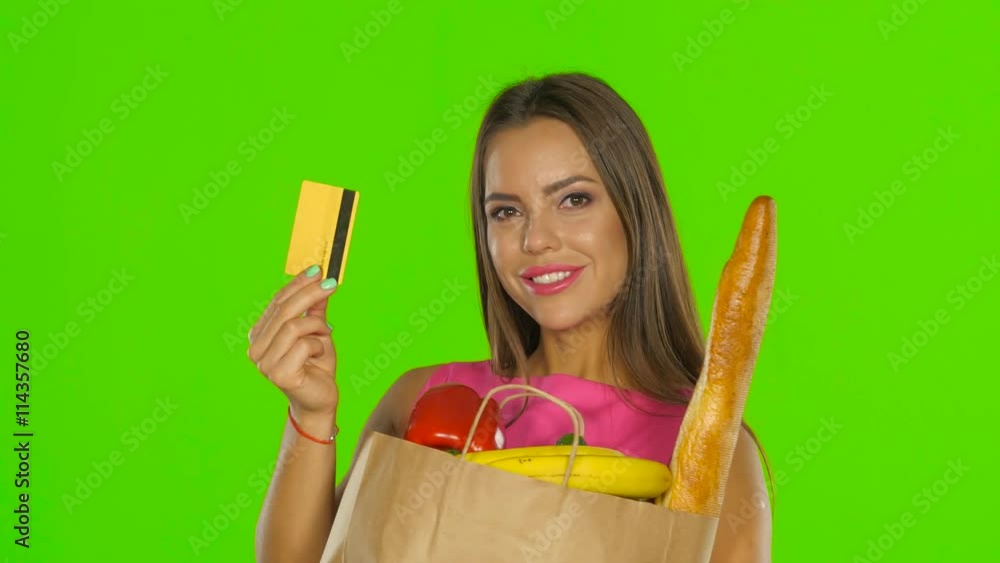 Girl in the calculation for the products used the gold card. Green screen. Close up Girl in the calculation for the products used the gold card. Green screen. Close up