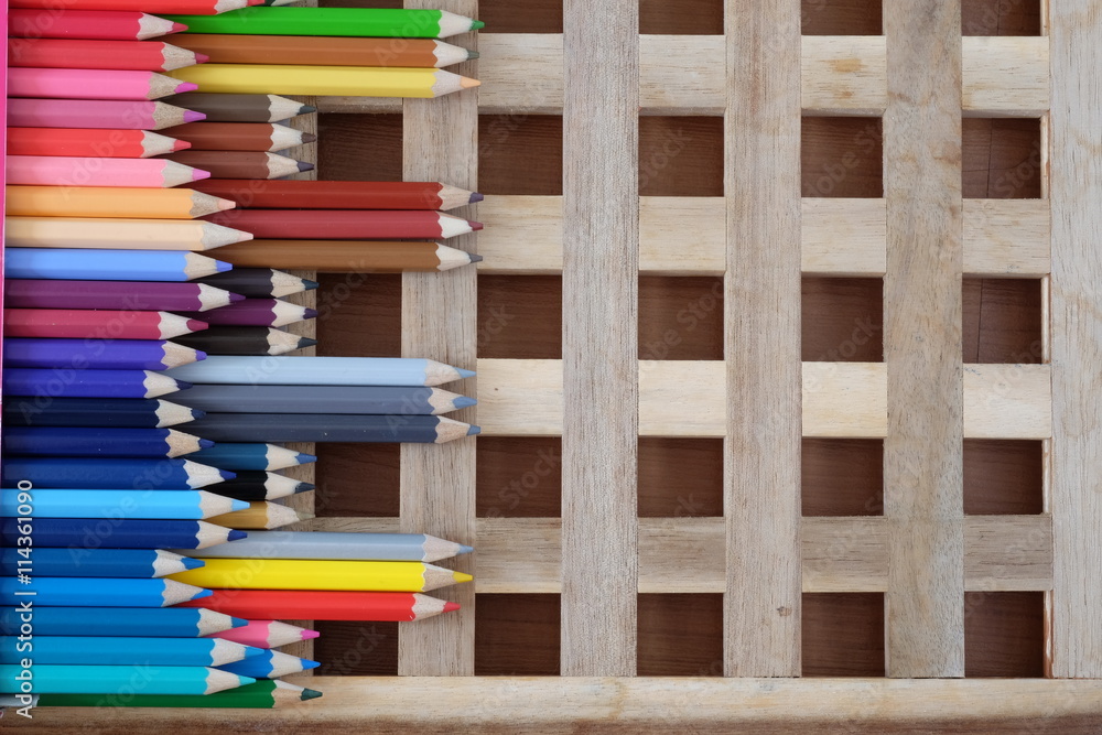 Colorful pencils on crossing of wooden background Colorful pencils on crossing of wooden background