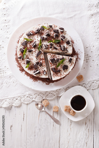 Delicious cheesecake with chocolate cookies closeup. Vertical top view

