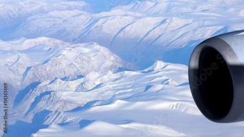 Greenland as seen from the sky, wing view with airplane turbine photo