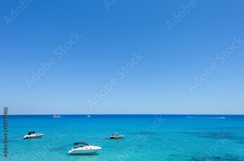 Photo of sea in protaras, cyprus island with boats and immaculate water. © frimufilms