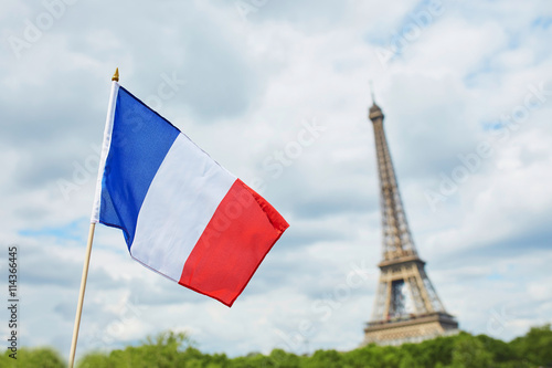 French national flag (tricolour) in Paris with the Eiffel tower in the background photo