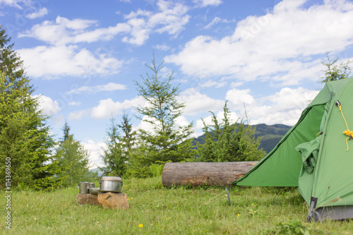 Camping in a mountainous area with cooking equipment.