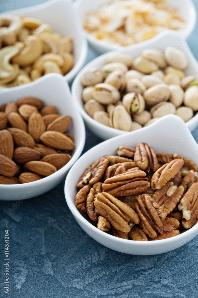 Variety of nuts in small bowls Variety of nuts in small bowls