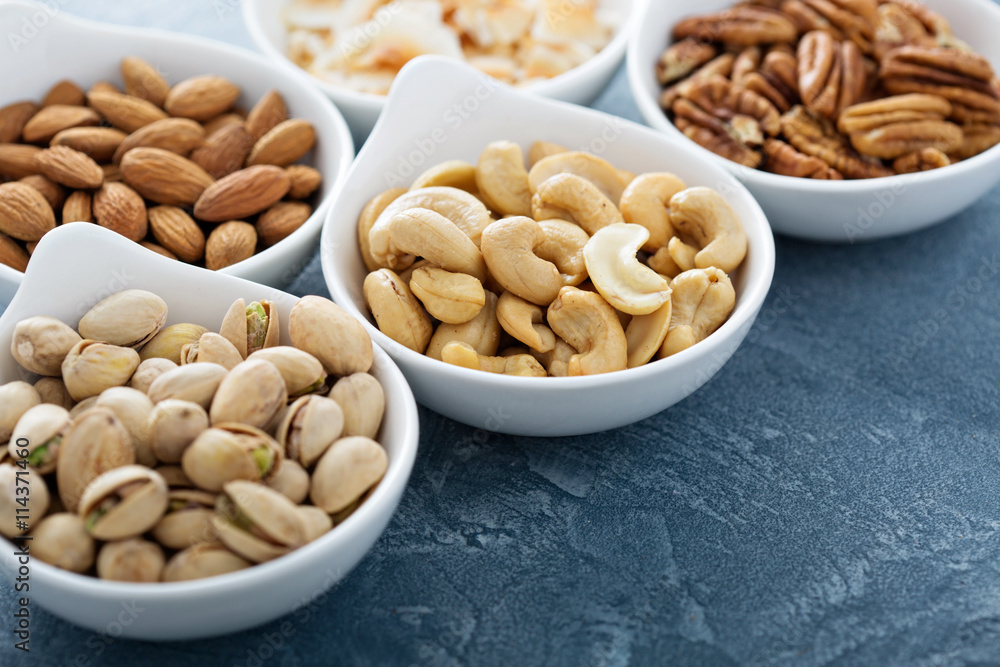 Variety of nuts in small bowls Variety of nuts in small bowls