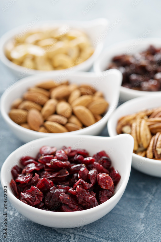 Variety of nuts and dried fruits in small bowls Variety of nuts and dried fruits in small bowls
