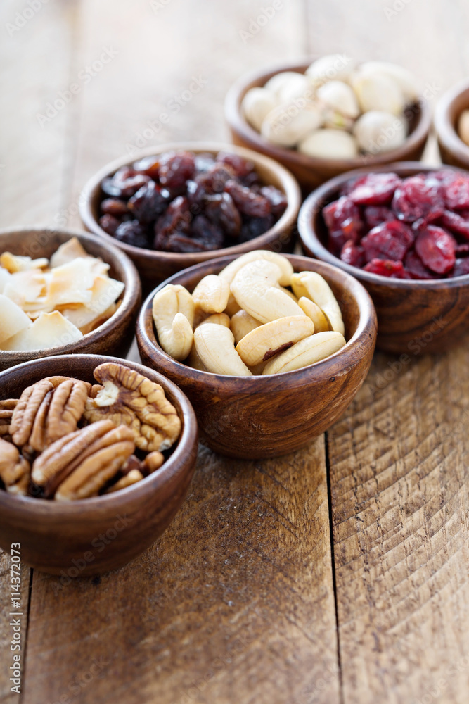 Variety of nuts and dried fruits in small bowls Variety of nuts and dried fruits in small bowls
