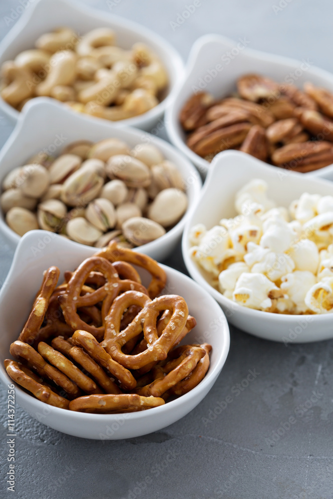 Variety of healthy snacks in white bowls