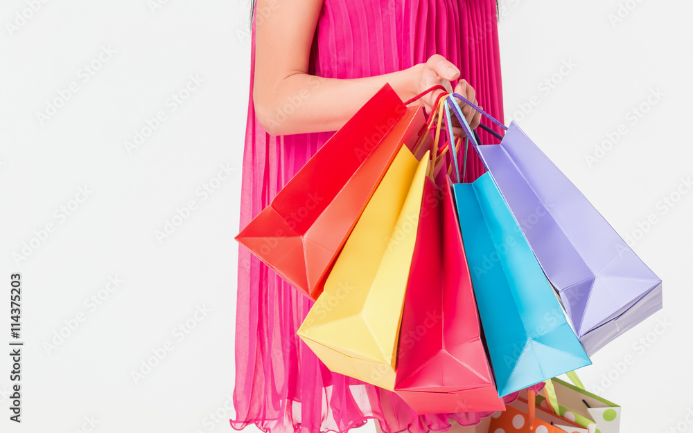 Unrecognizable woman holding multicolored shopping bags