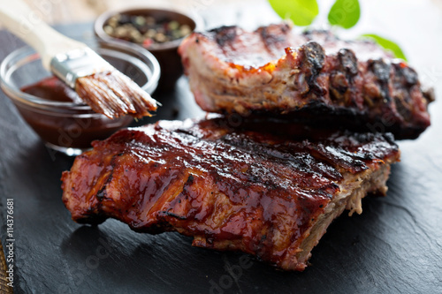 Fototapeta Grilled pork baby ribs with bbq sauce
