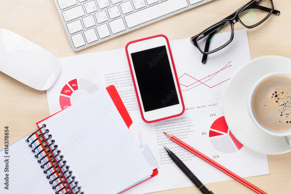 Office workplace with phone, charts and coffee Office workplace with phone, charts and coffee