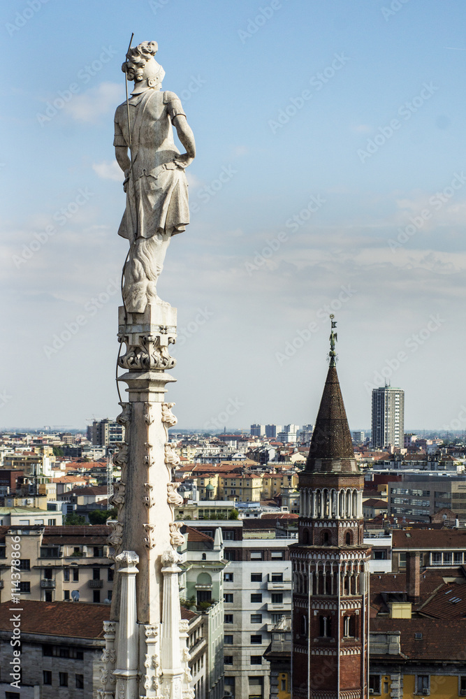 Milan, panoramic skyline. One of the religious statues of Duomo