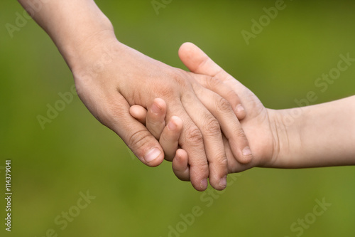 hands of two children on blurred background, friendship concept © rodimovpavel