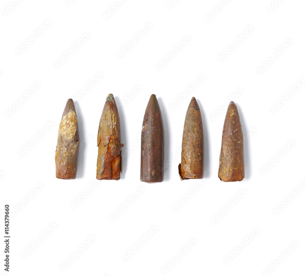 Historical war memorabilia - Rusty old antique bullets / shells isolated on a white background Historical war memorabilia - Rusty old antique bullets / shells isolated on a white background