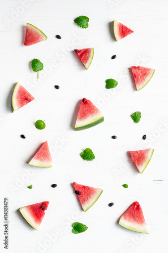 Fototapeta Naklejka Na Ścianę i Meble -  pattern of watermelon slices on wooden white background, top view, flat lay