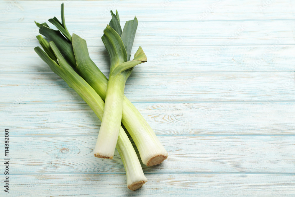 Green leeks on a grey wooden table Green leeks on a grey wooden table