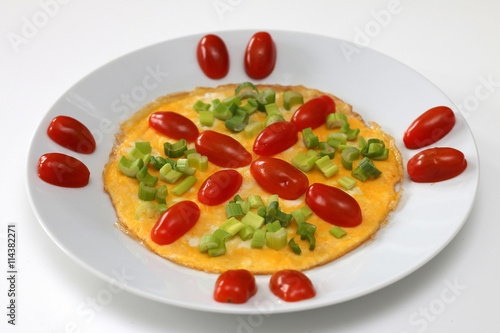 Omelette with cherry tomatoes and green onion, isolated