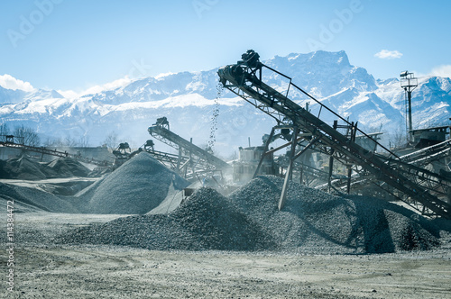 stone crusher at work, the extraction of gravel, the mining and production of crushed stone photo