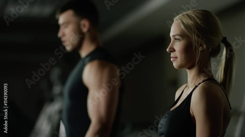 young woman and man doing a fitness workout with dumbbells