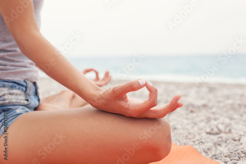 Meditating. Woman doing yoga. Close-up