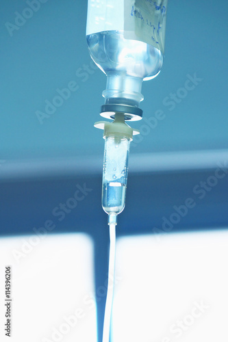 Medical drip on blurred background of hospital room