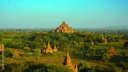 Video 3840x2160 - Tracking, panoramic shot of an enchanting landscape in Bagan, Myanmar, with the spires of ancient, Buddhist temple structures seeming to sprout up in all directions.