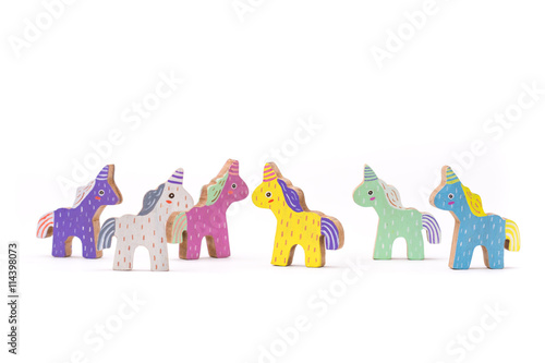 Wooden colorful unicorn horses on white background