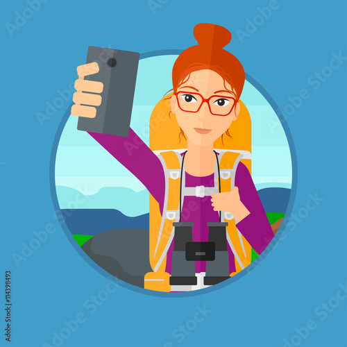 Woman with backpack making selfie.