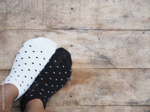 feet wearing black and white polka dot socks