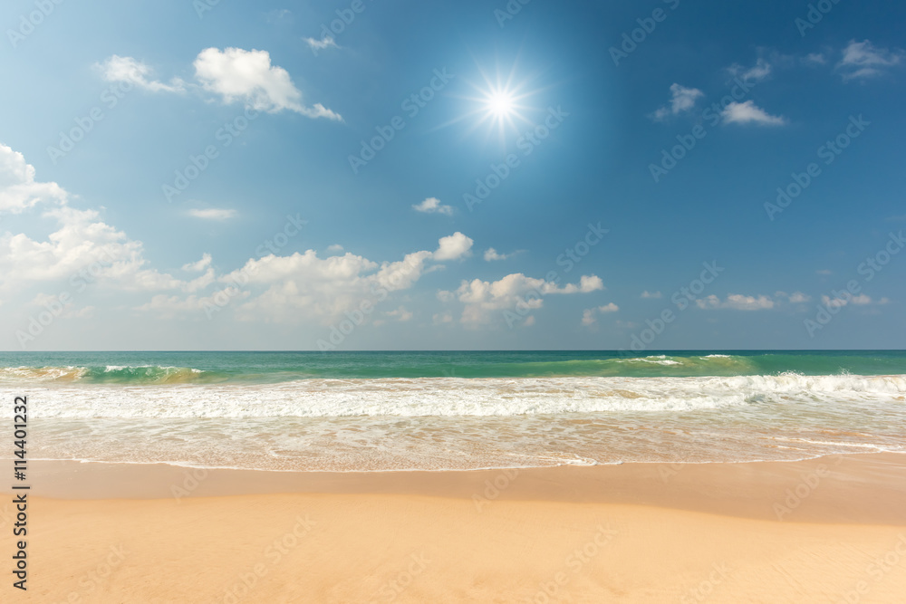 Beautiful beach and tropical sea with sun burst