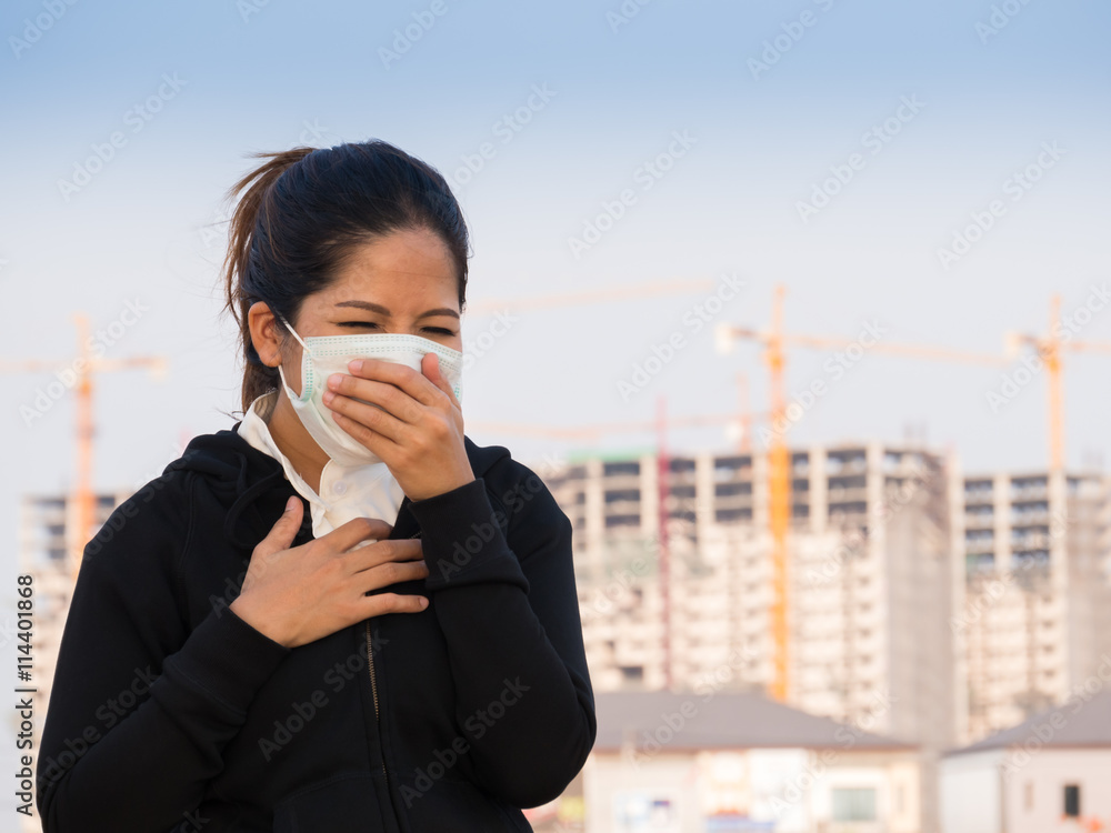 Plakat asian woman wearing face mask and coughing by pollution