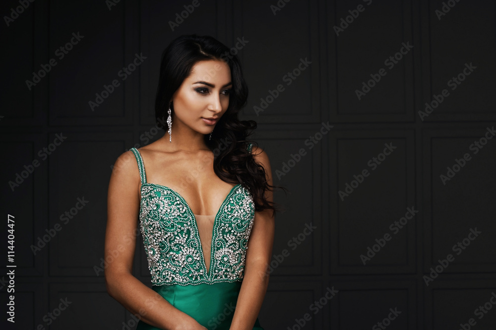 raven haired indian lady posing in studio against gray wall raven haired indian lady posing in studio against gray wall
