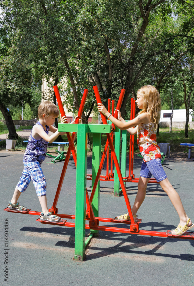 Fototapeta premium Children train on the simulator in park