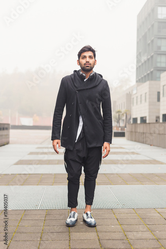 Handsome Indian man posing in an urban context