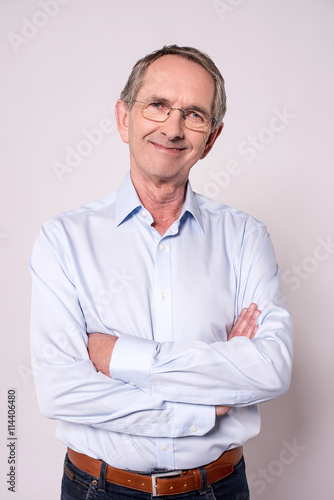 Picture of elderly man with crossed arms. © stockyimages