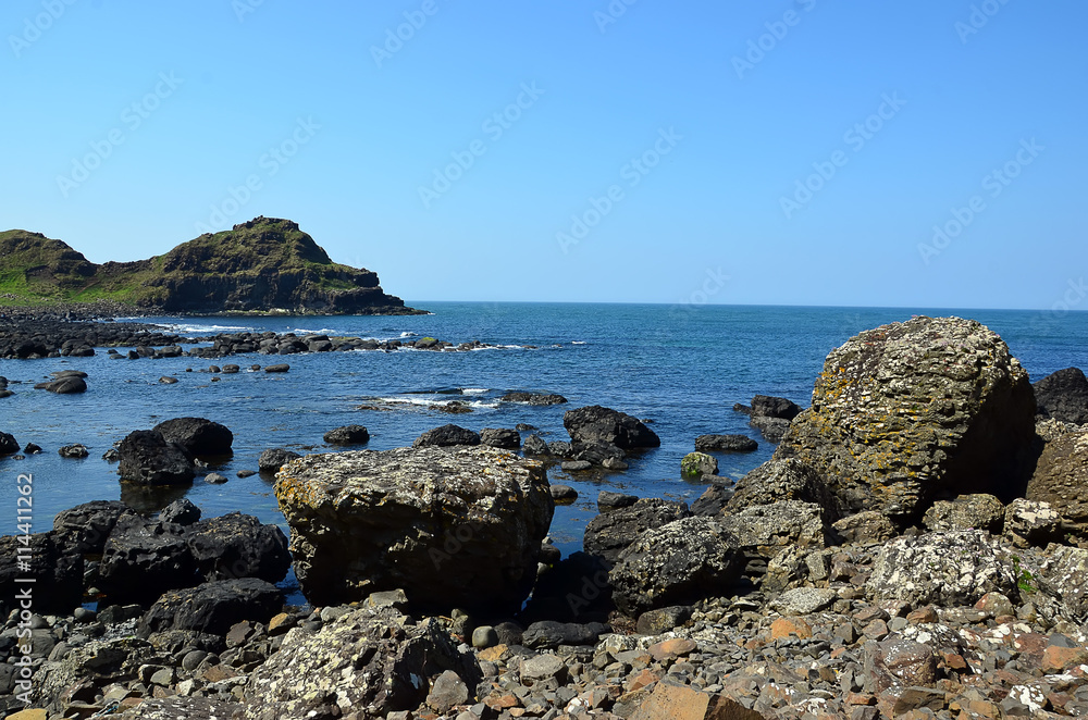 rocky coast with many rocks in Ireland with blue sky