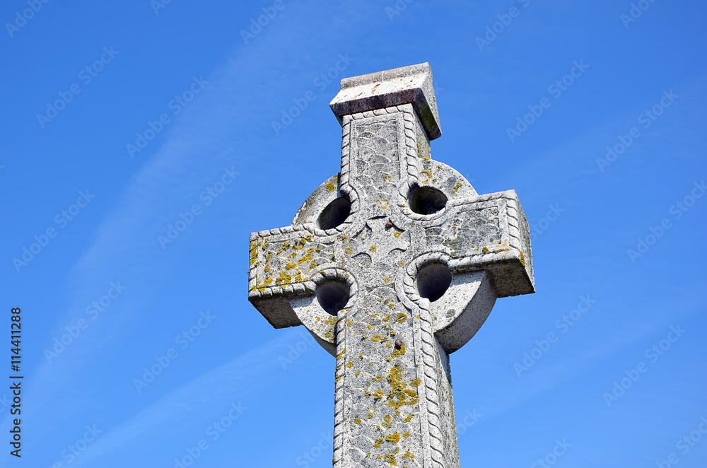 big old stone celtic cross and blue sky big old stone celtic cross and blue sky