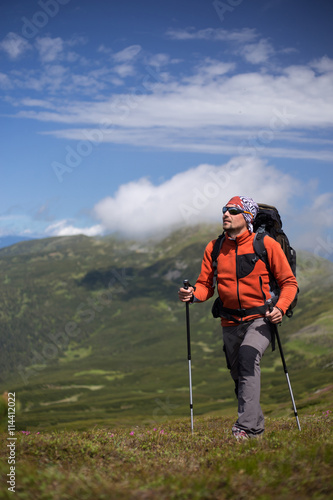 Summer hiking in the mountains with a backpack and tent. © egorovdn22