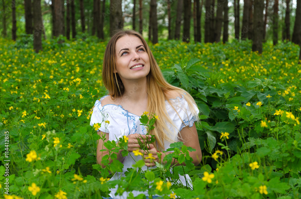 Portrait of beautiful young woman in forest among flowers Portrait of beautiful young woman in forest among flowers