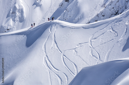 Snowboard freeride, snowboarders and tracks on a mountain slope. Extreme sport.