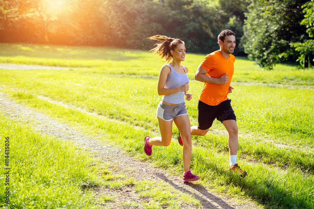 Athletic couple jogging in nature
